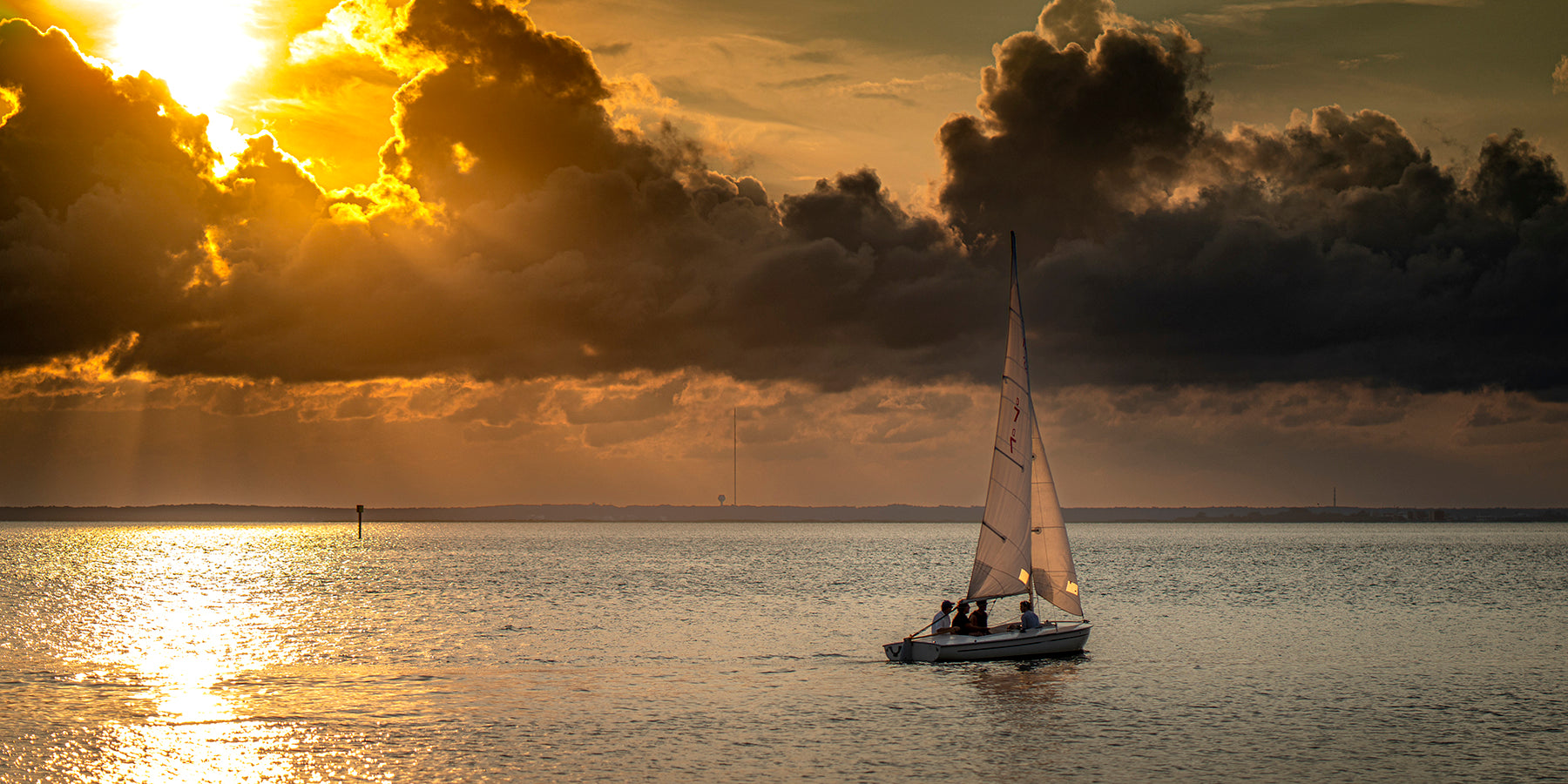 A boat sailing into the sunset