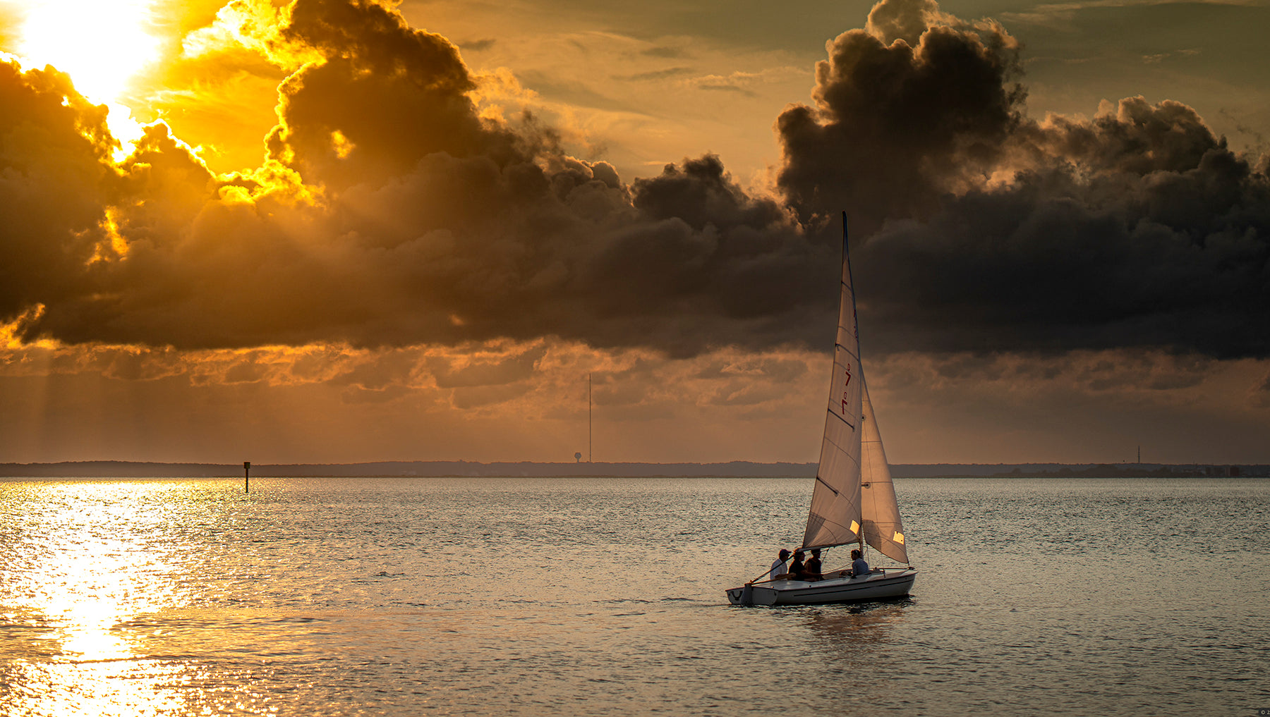 A boat sailing into the sunset